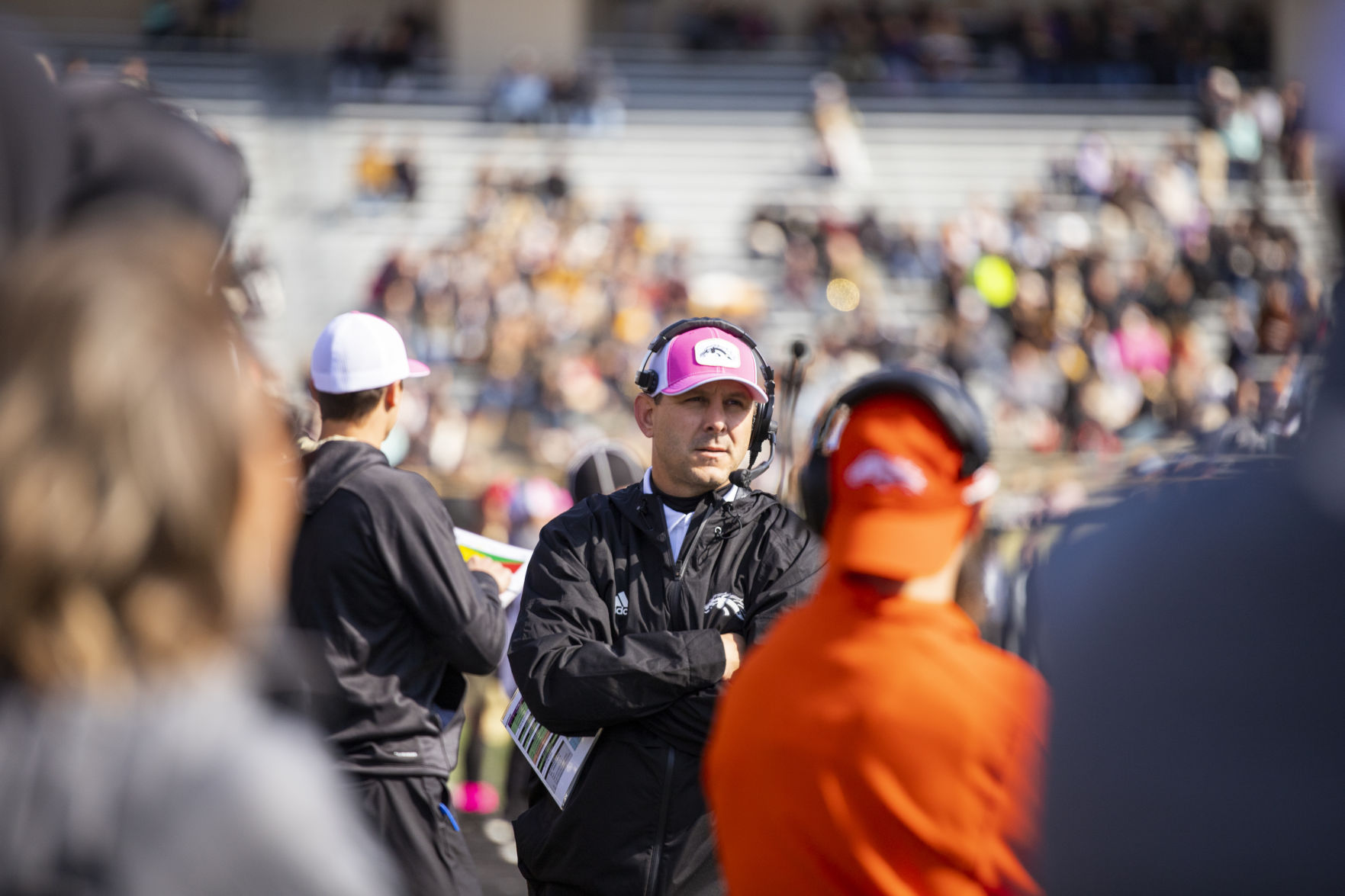 Head football coach Tim Lester watches